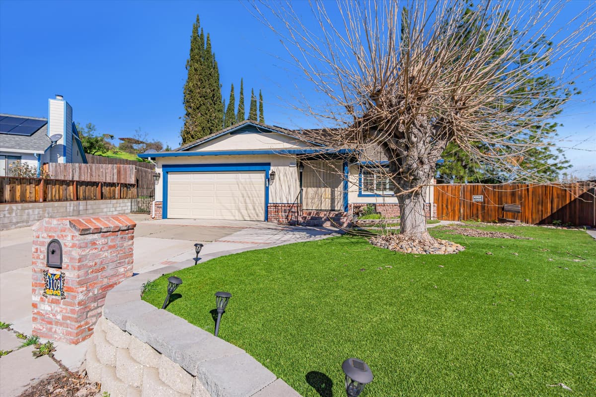 A single-story home with manicured front lawn, professionally managed by Bay Vista PM.