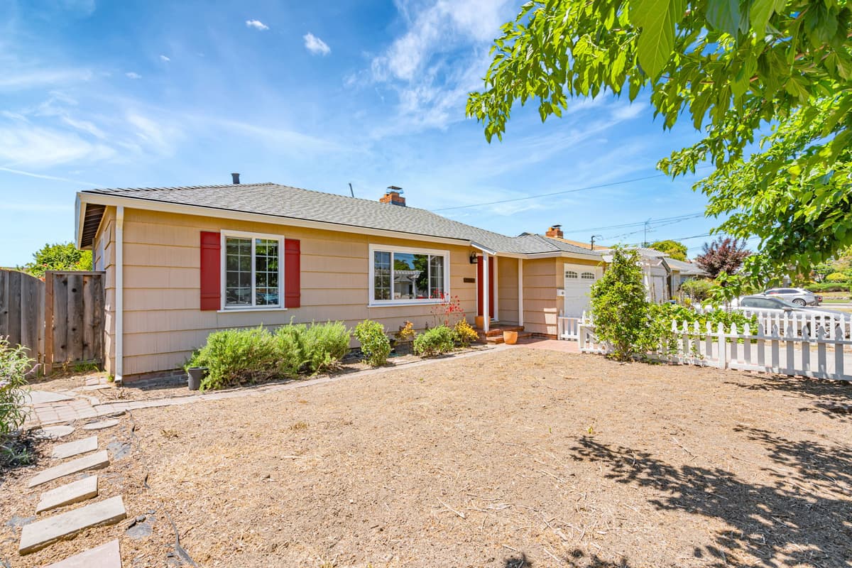 A single-story Bay Area home with red shutters and a manicured front, professionally managed by Bay Vista PM.